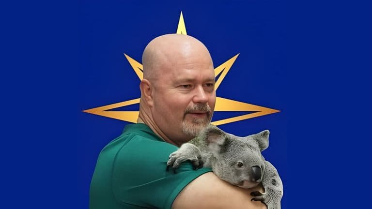 Scott MacWherter holding a koala, with a bold star-shaped graphic in the background, symbolizing his adventure mindset.
