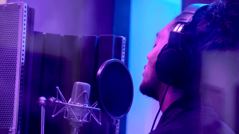 Almachize in the studio, blending music and business through creative expression.
