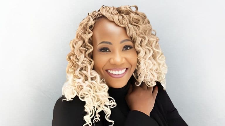 Dr. Trina R. Wilson, smiling confidently in black attire, launches the 'Aligned and Abundant' journal for entrepreneurs.