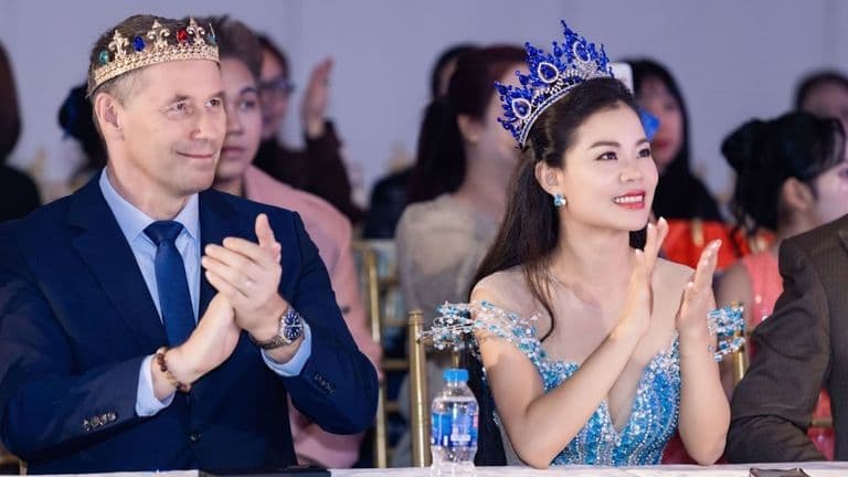 Tan Le and Dieter Bruhn, crowned Miss & Mister Mighty Entrepreneur International 2025, applauding at an event together.