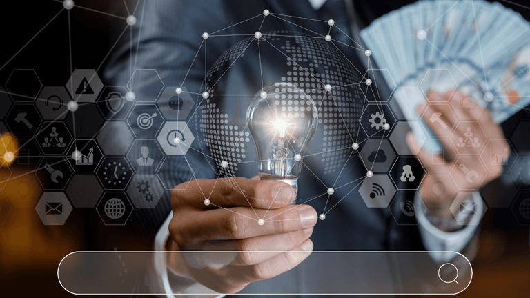 Business professional holding a lit light bulb and cash with digital business icons overlay.