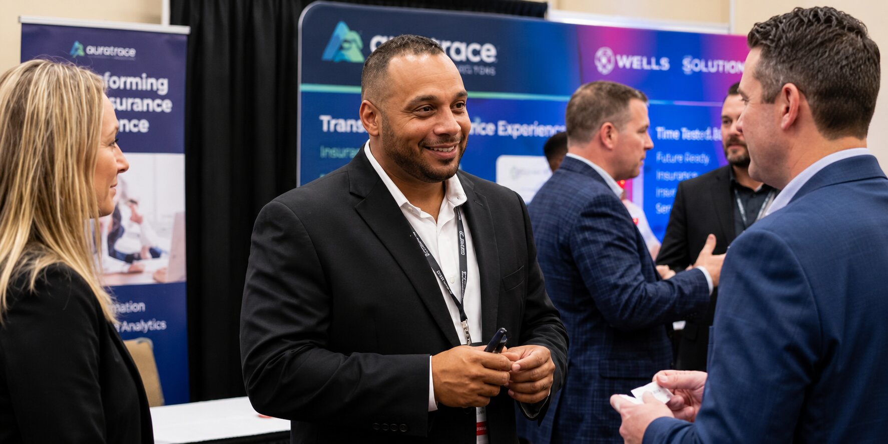 Gino Murin networking with business professionals at an industry conference.