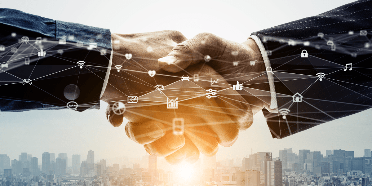 Business professionals shaking hands with digital technology icons over a city skyline.