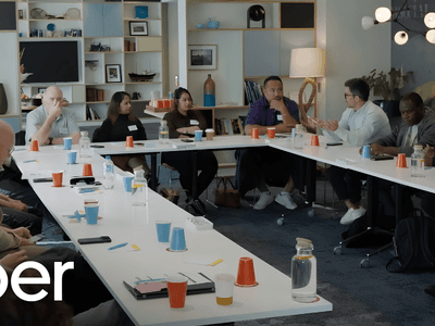 A diverse group of people participating in a meeting around a long table