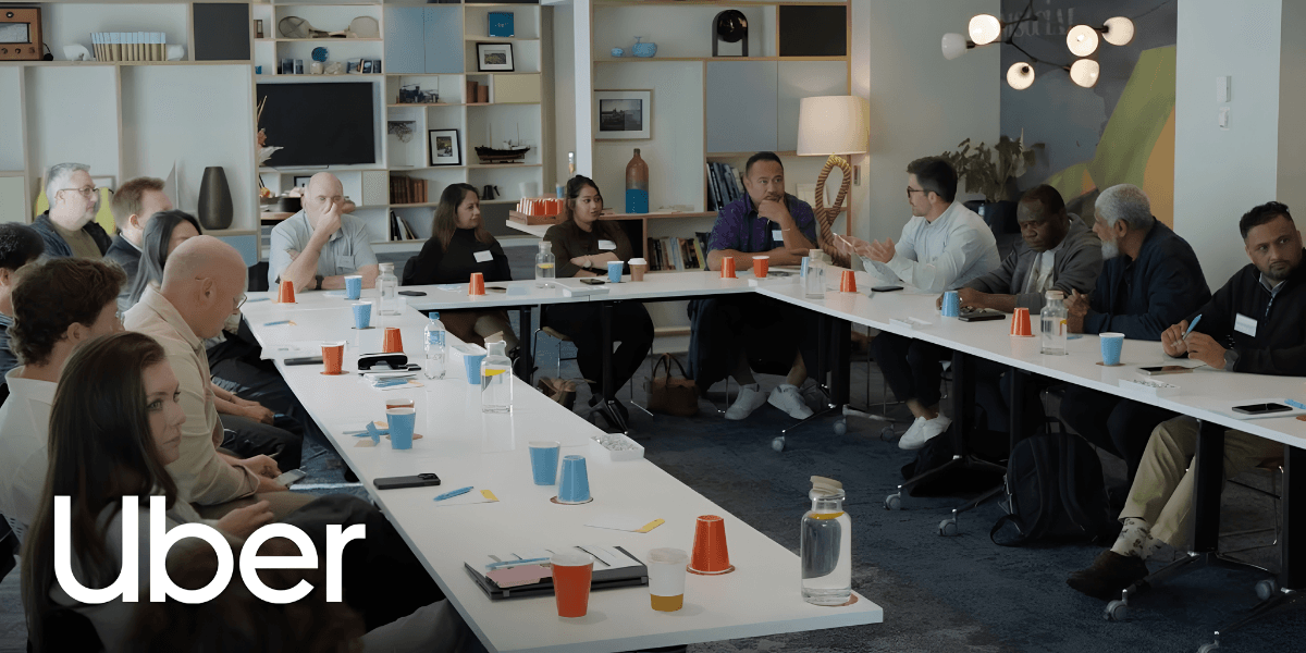 A diverse group of people participating in a meeting around a long table
