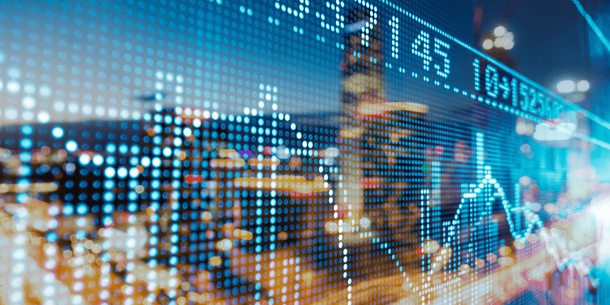 Digital stock market data overlaying a blurred cityscape at night