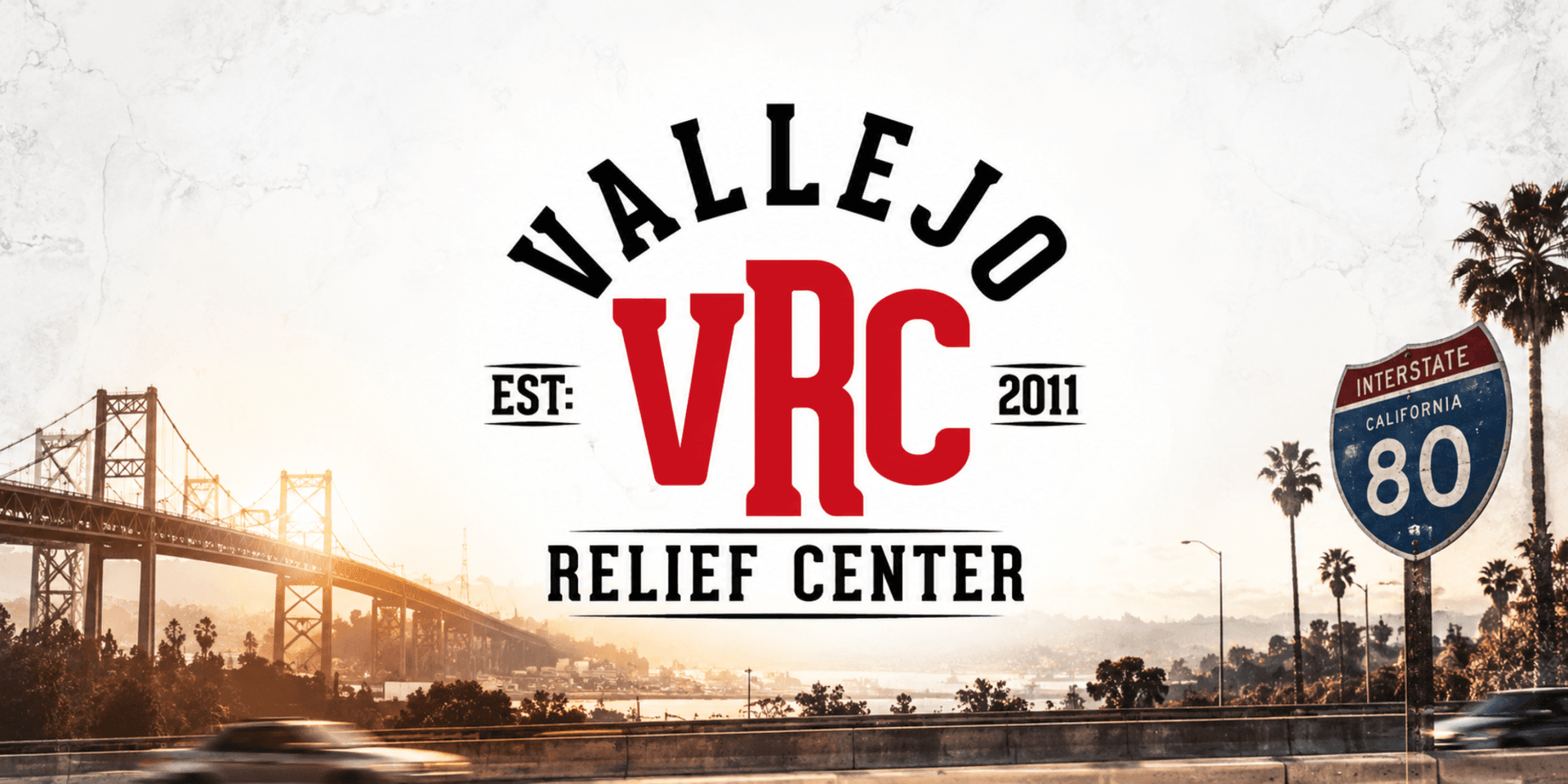 Logo for Vallejo Relief Center with a bridge and highway in the background