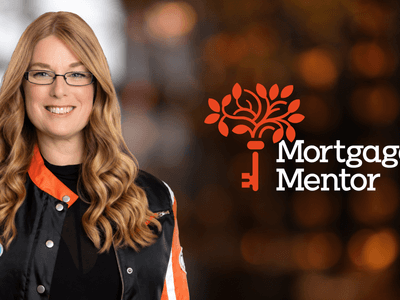 Woman with long hair in a black and orange jacket smiling beside a logo