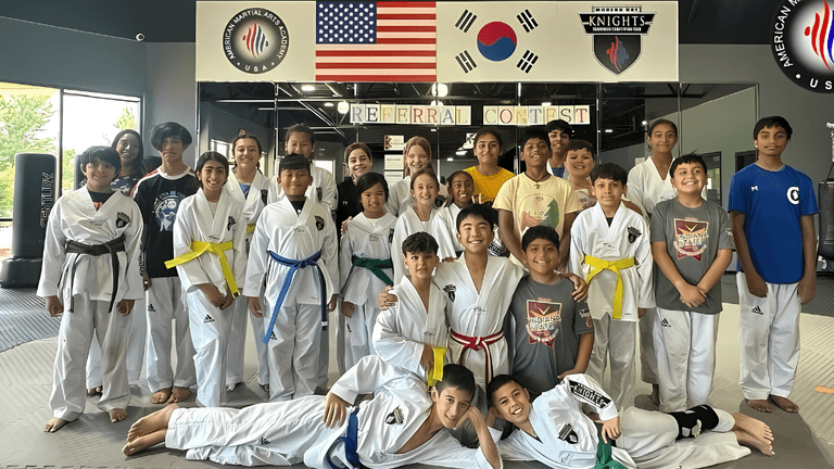 A group of young martial artists at American Martial Arts Academy, showcasing teamwork, discipline, and leadership in a supportive environment.