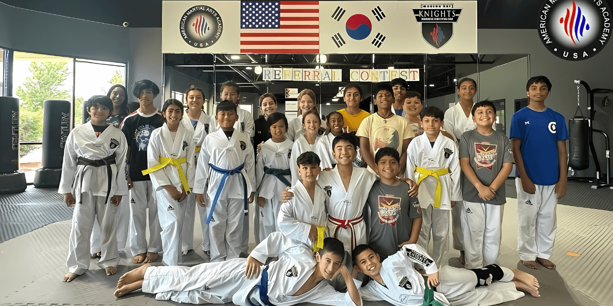 A group of young martial artists at American Martial Arts Academy, showcasing teamwork, discipline, and leadership in a supportive environment.