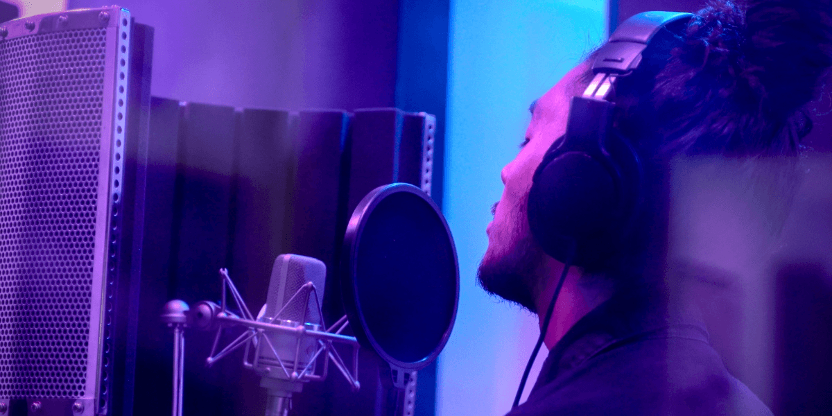 Almachize in the studio, blending music and business through creative expression.