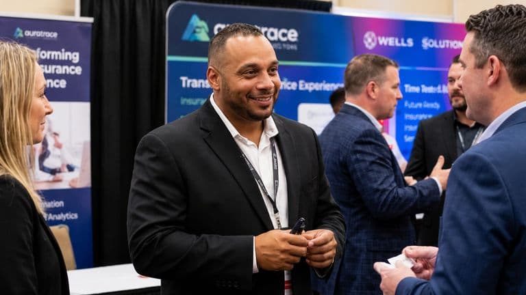Gino Murin networking with business professionals at an industry conference.