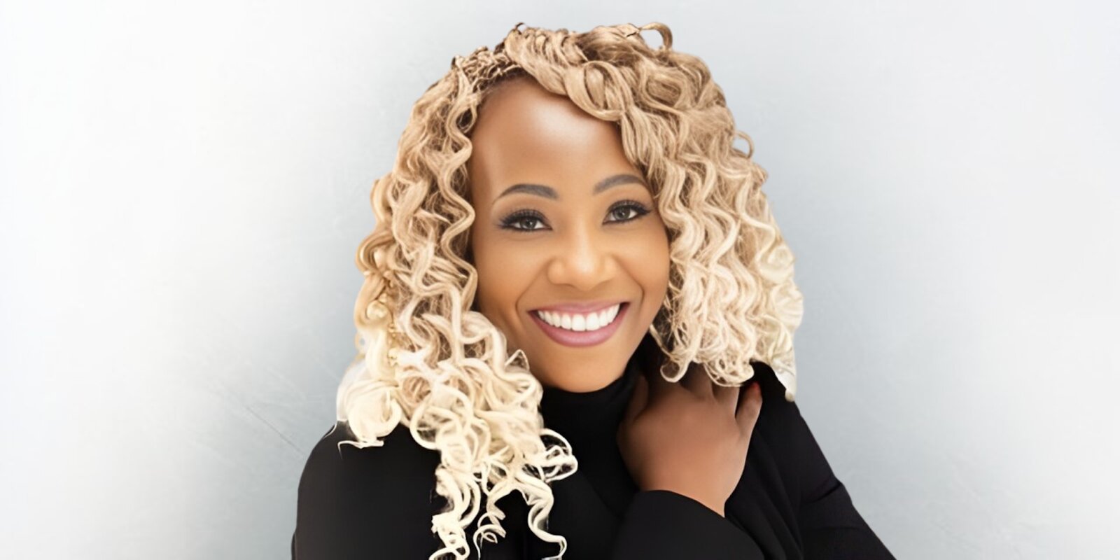 Dr. Trina R. Wilson, smiling confidently in black attire, launches the 'Aligned and Abundant' journal for entrepreneurs.