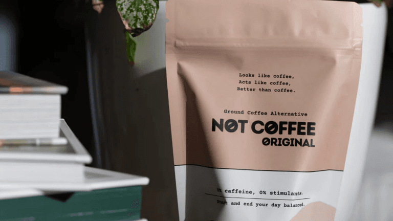 Sila Gatti, founder of Not Coffee, holding a cup of her caffeine-free blend in a modern workspace, representing the brand’s mission to offer healthy coffee alternatives.