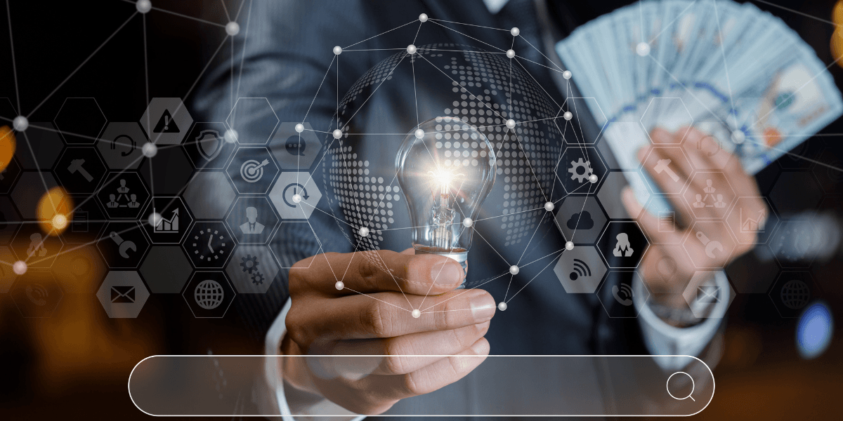 Business professional holding a lit light bulb and cash with digital business icons overlay.