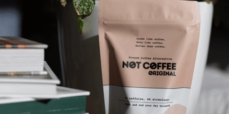 Sila Gatti, founder of Not Coffee, holding a cup of her caffeine-free blend in a modern workspace, representing the brand’s mission to offer healthy coffee alternatives.