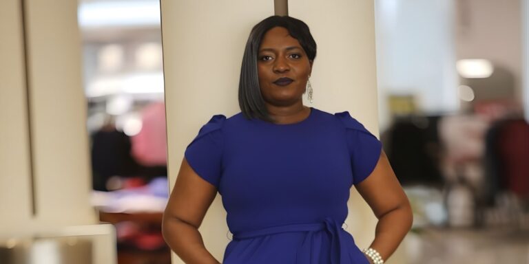 "Chantale C. Nyonka confidently posing in a blue dress, embodying empowerment, purpose, and authenticity through mindset coaching."