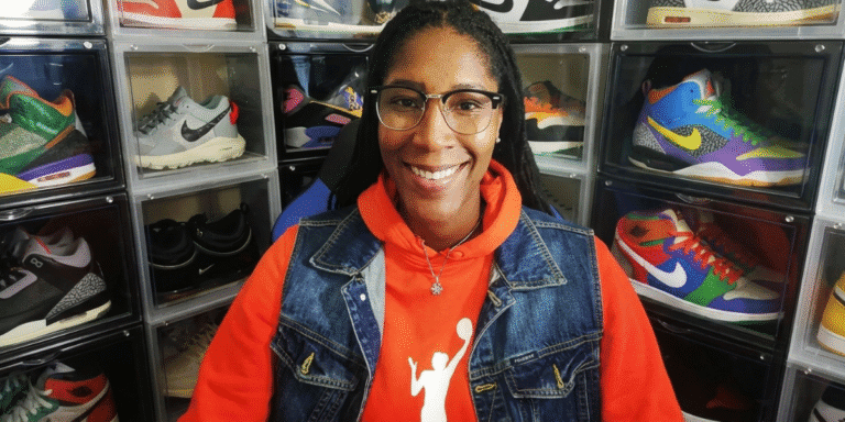 Michelle Snow Builds The Pivot Into Power Michelle Snow smiling in front of a display of colorful athletic sneakers.